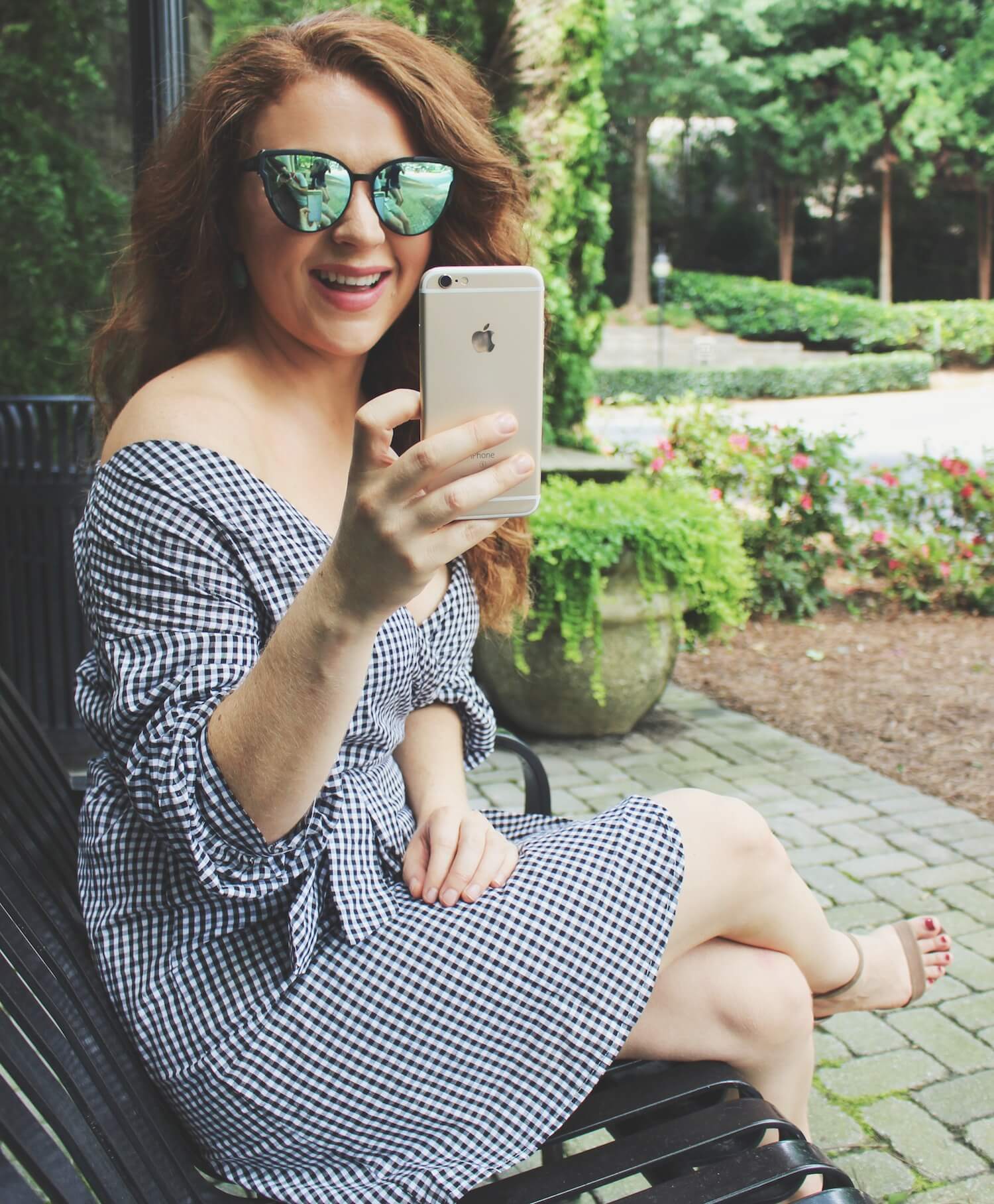 Katherine laughs taking a picture on her phone